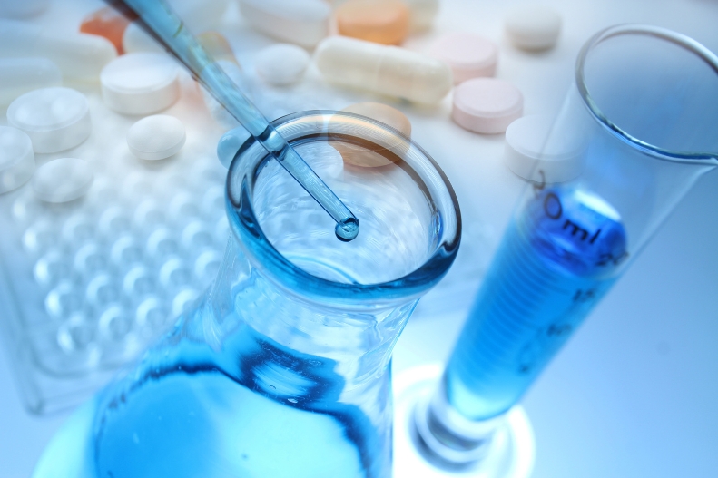 Pipette dispensing into a beaker during laboratory analysis