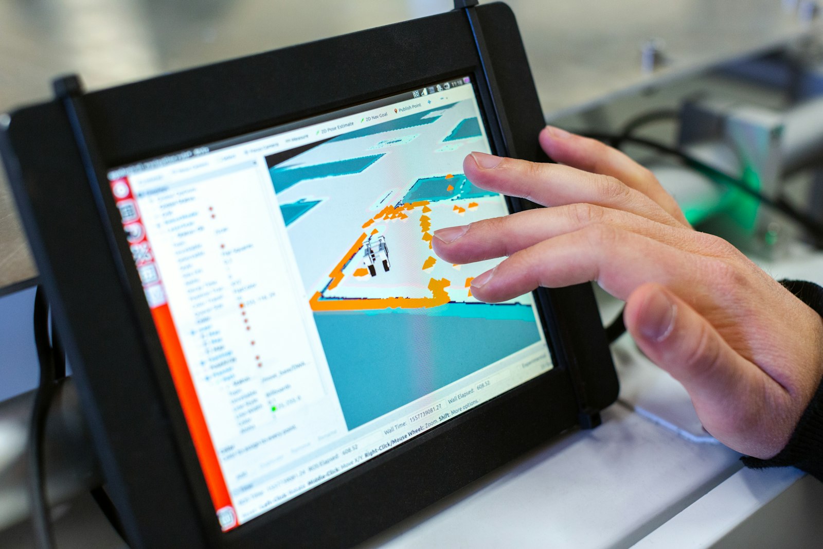A technician reviewing thermal mapping data on a touchscreen analyser