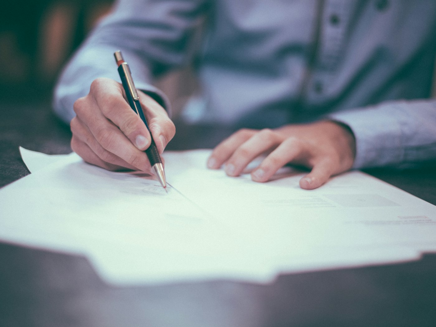 A specialist completing protocol documents with a pen